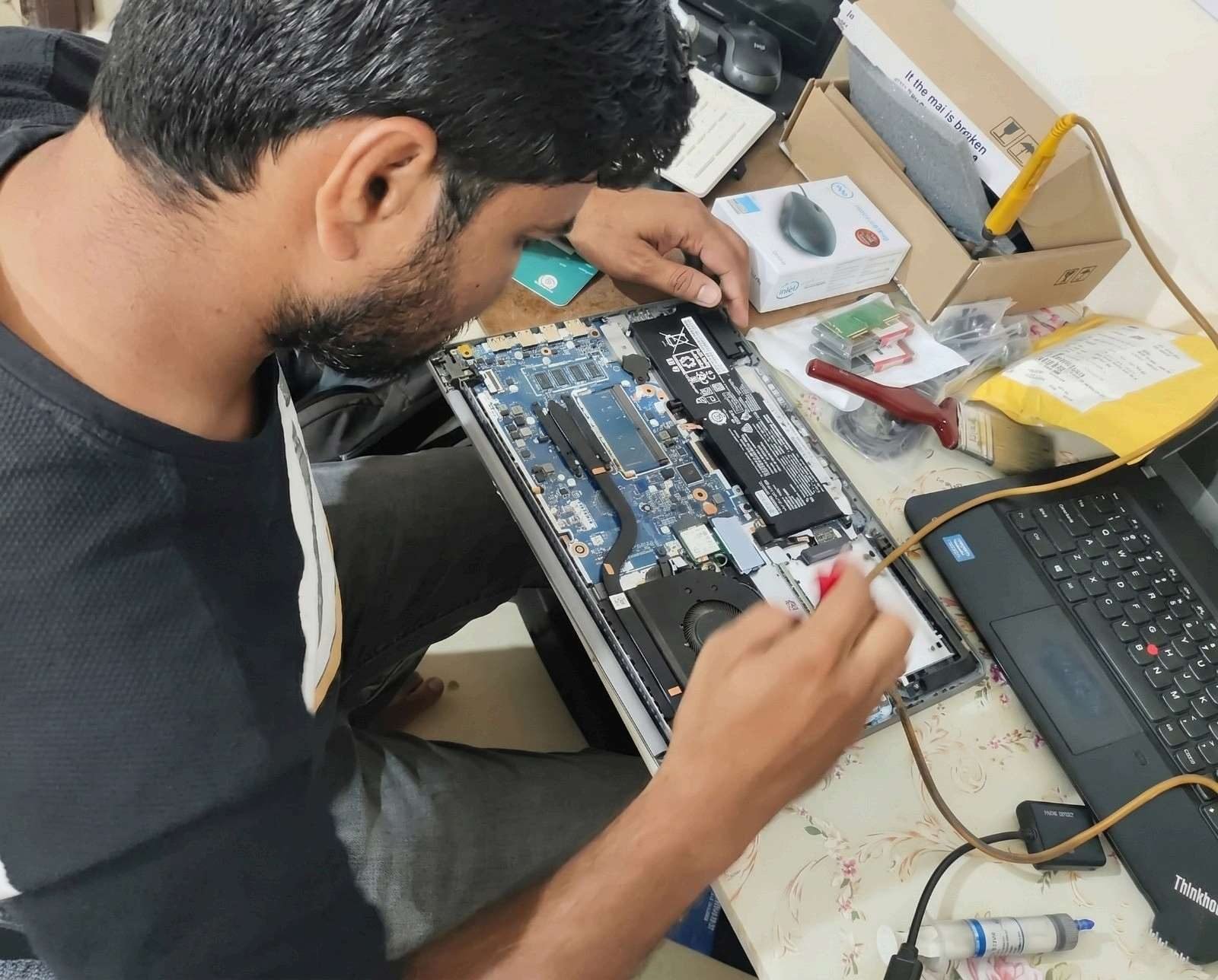 Background-checked SwiftIT Solutions technician arriving at a Hyderabad customer's home with a laptop